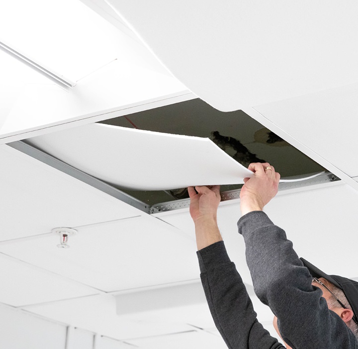 Individual replacing a ceiling tile